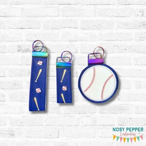 May include: Three baseball-themed keychains. Two are blue with baseball and bat embroidery. The third is a round baseball design with red stitching. All have iridescent hardware and a key ring.