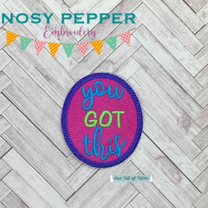 May include: A pink and purple embroidered patch with the text "you got this" in green and blue lettering.
