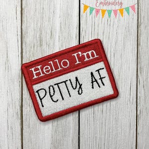 May include: Red and white embroidered patch with the text "Hello I'm Petty AF" in black lettering.