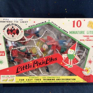 May include: A box of 10 World-Wide Little Pixie Lites Christmas lights. The lights are miniature and feature a pixie design. The box is red, white, and green with the text "World-Wide Decorative Lites" and "Little Pixie Lites".