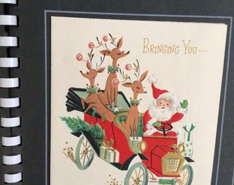 May include: Vintage Christmas card featuring Santa Claus driving a red car with reindeer. The card has a festive design with the text "Bringing You..." and is part of a set of 25 cards and envelopes.