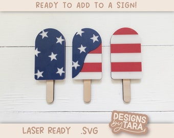 May include: Three popsicle-shaped SVG cut files featuring red, white, and blue American flag designs. The designs are ready to be added to a sign.