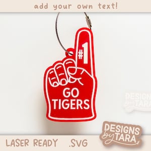 May include: A red foam finger with the number 1 and the words "GO TIGERS" in white. The foam finger is attached to a metal wire. The text "add your own text!" is at the top, and "LASER READY .SVG" is at the bottom.