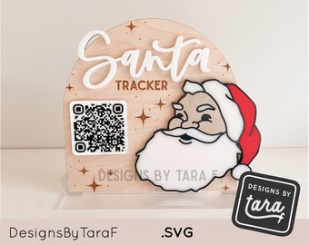 May include: A wooden Santa tracker sign with a white Santa face, a red hat, and a white beard. The sign also has a QR code and the text "Santa Tracker" in white letters. The sign is on a clear acrylic stand. The text "Designs By Tara F" is on the bottom left of the image.