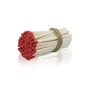 May include: A bundle of red-tipped wooden matches tied together with twine. The matches are arranged in a circular shape, with the red tips facing outward.