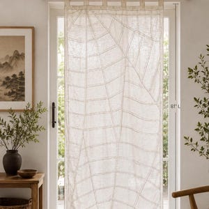 May include: A semi-sheer off-white curtain panel featuring a geometric grid pattern of stitched lines. The curtain hangs from a wooden rod with fabric tabs and measures 40 inches wide by 81 inches long, as indicated by the printed text labels.
