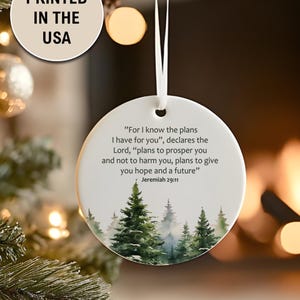 An aesthetic Christian Christmas ornament with bible verse from Jeremiah 29:11 "For I know the plans I have for you", featuring a watercolor pine trees design . Personalize it with name and date and it becomes a unique religious keepsake gift for a men and women. 

Our meticulously handprinted keepsake ornaments are crafted from premium quality ceramic using high quality ink. Will never fade. Scratch resistant. 100% satisfaction guarantee.
