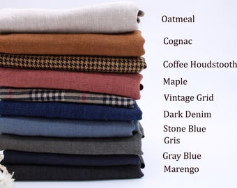 May include: A stack of folded fabric swatches in various colours and patterns, labelled as Oatmeal, Cognac, Coffee Houndstooth, Maple, Vintage Grid, Dark Denim, Stone Blue, Gris, Gray Blue, and Marengo, arranged vertically against a plain background.
