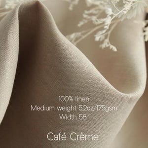 May include: A piece of light beige 100% linen fabric with a medium weight of 5.2oz/175gsm and a width of 58 inches. The fabric is draped in soft folds and features the text 100% linen, Medium weight 5.2oz/175gsm, Width 58, and Caf&eacute; Cr&egrave;me.