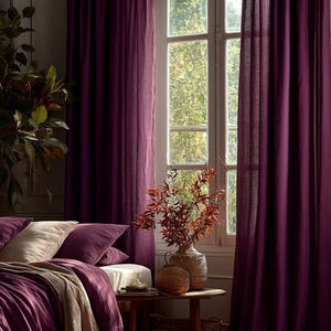May include: A bedroom scene with rich purple curtains and a window. The bed is dressed in matching purple bedding and pillows, with a beige throw. A small wooden table displays decorative vases and a plant arrangement.