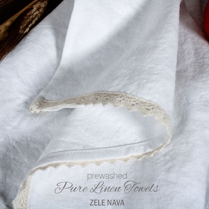 May include: White linen kitchen towels with a crocheted edge. The towels are pre-washed and labeled "Pure Linen Towels" and "ZELE NAVA".