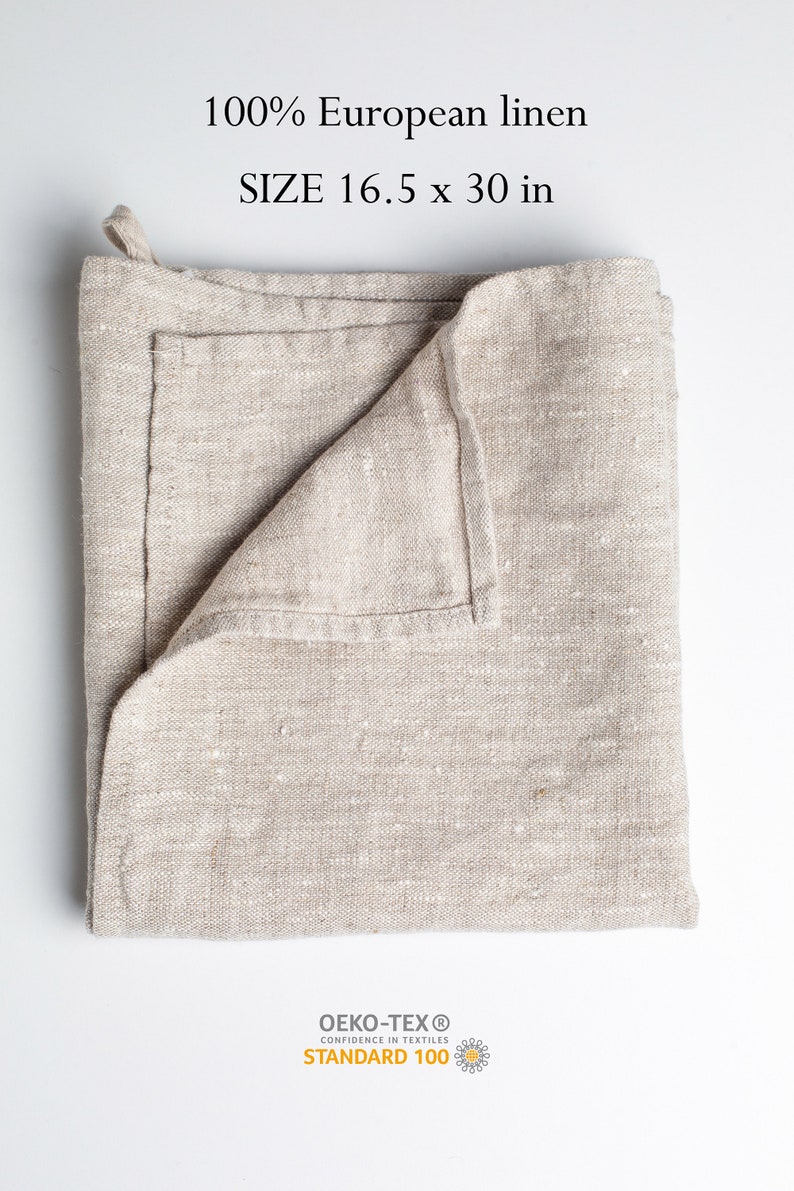 May include: A folded beige linen kitchen towel with the text "100% European linen SIZE 16.5 x 30 in" and the Oeko-Tex Standard 100 logo.