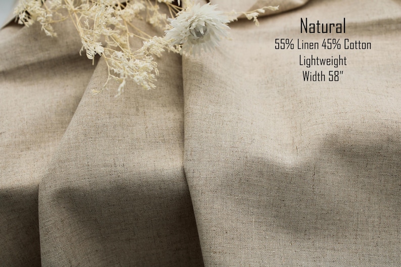 May include: A piece of natural-colored fabric with a visible weave, composed of 55% linen and 45% cotton. The material is lightweight with a width of 58 inches. Dried white flowers are placed on top of the folded, textured textile.