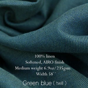 May include: Close-up of green-blue twill fabric, 100% linen with a softened AIRO finish. The medium-weight fabric is 58 inches wide and weighs 6.9oz/235gsm. The fabric is a deep teal color with visible diagonal weave.