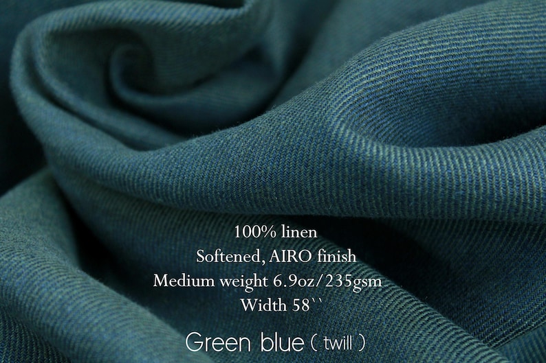 May include: Close-up of green-blue twill fabric, 100% linen with a softened AIRO finish. The medium-weight fabric is 58 inches wide and weighs 6.9oz/235gsm. The fabric is a deep teal color with visible diagonal weave.