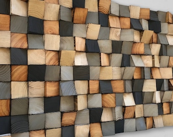 May include: A wall art piece made of wood blocks in various shades of brown, gray, and black. The blocks are arranged in a staggered pattern, creating a textured and dimensional effect.