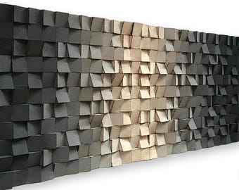 May include: A wall art piece made of wood blocks in shades of gray and beige. The blocks are arranged in a staggered pattern, creating a textured and dimensional effect.