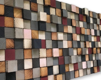 May include: A wall art piece made of wooden blocks in various shades of brown, gray, black, and pink. The blocks are arranged in a staggered pattern, creating a textured and modern look.