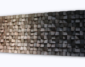 May include: A wall art piece made of wood with a gradient of colours from light brown to dark grey. The wood is arranged in a grid pattern with each piece slightly raised, creating a textured surface.