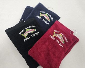 May include: Three embroidered towels with a rainbow trout design and the text "Fish Around Find Trout". The towels are black, navy blue, and burgundy.