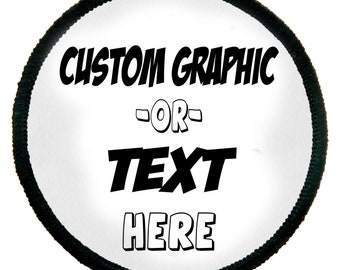 May include: Round patch with a white center and a black border. The patch features the words "CUSTOM GRAPHIC" above "OR" and "TEXT" above "HERE" in bold, black lettering. The patch is designed for customization.