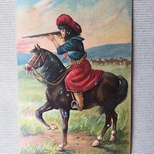 Antique post card with rifle shooting woman atop horse