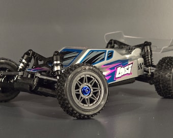May include: A silver and blue remote control car with a clear rear wing. The car has black tyres and a pink and blue design on the side. The car has the word "Losi" printed on the side.