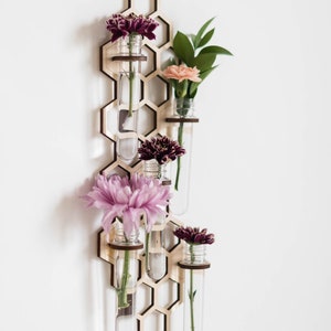 Hanging wall bud vase with pink and magenta and orange flowers