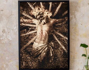 May include: A black and white photograph of a statue of a person with their arms outstretched, surrounded by branches. The statue is weathered and appears to be made of stone.