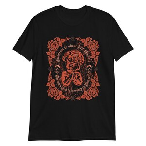 May include: Black t-shirt with a red graphic design featuring a stylized image of a person with the text "Satanism is about Self Worship. The only God to worship is yourself."