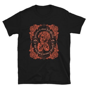 May include: Black t-shirt with a red graphic design featuring a stylized image of a person's head with the text "Satanism is about self worship. The only god to worship is yourself."