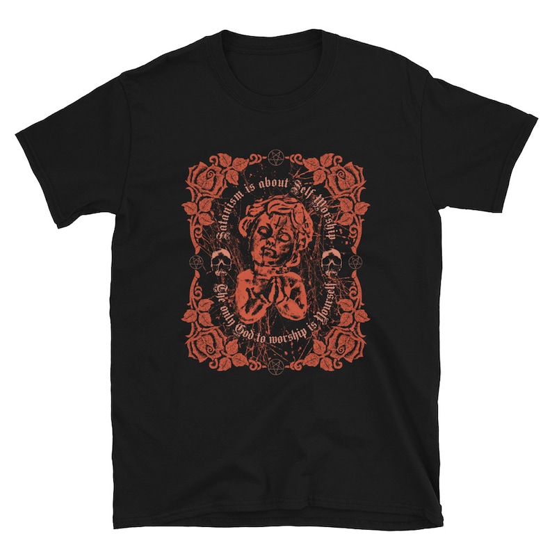 May include: Black t-shirt with a red graphic design featuring a stylized image of a person's head with the text "Satanism is about self worship. The only god to worship is yourself."