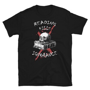 May include: Black t-shirt with a white graphic design of a skull on top of a book. The graphic design includes the text "Reading Kills Ignorance" with a red X through it.