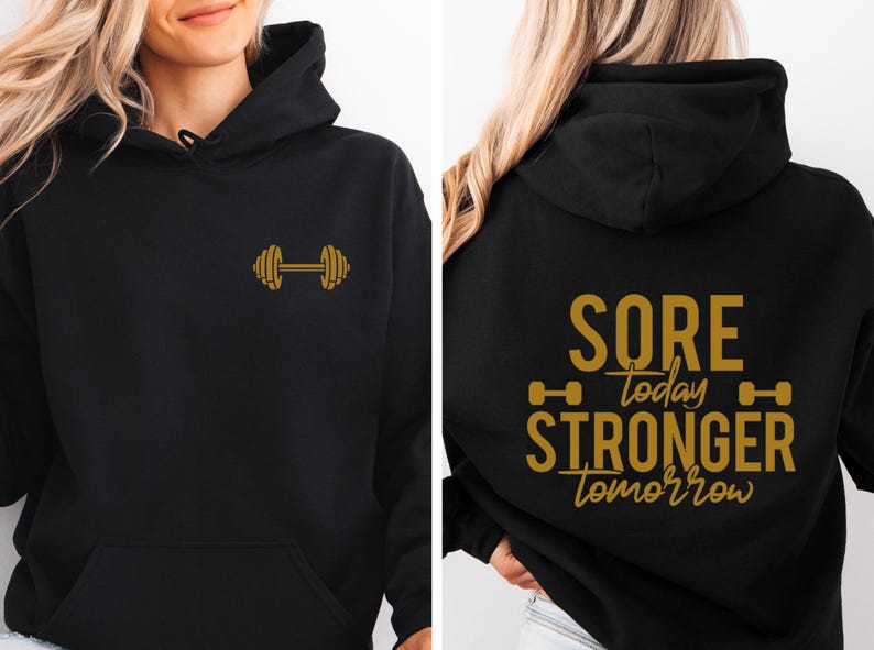 May include: Black hoodie with a gold dumbbell graphic on the front and the text "SORE today STRONGER tomorrow" with a gold dumbbell graphic on the back.
