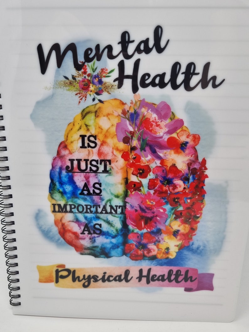 K&ouml;nnte beinhalten: Ein wei&szlig;es Notizbuch mit Spiralbindung und einer bunten Gehirnabbildung sowie dem Text "Mentale Gesundheit ist genauso wichtig wie k&ouml;rperliche Gesundheit".