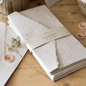 Large handmade letter-size envelopes made from recycled paper and dried flowers with self-adhesive wax seals