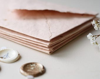 Handmade orange envelopes made from recycled paper with self-adhesive wax seals