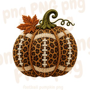 May include: A decorative pumpkin featuring a brown and black leopard print pattern, accented with beige stitched football-style laces along the vertical ribs. The pumpkin is topped with a textured green stem and a single orange maple leaf.