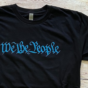 Equal Human - “We the People- UNITE” Unisex Fitted Tee (Black)