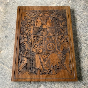 May include: A wood carving of a man with a long beard and a crown, holding a book with celestial symbols. He is surrounded by birds and other figures. The carving is on a dark wood background.