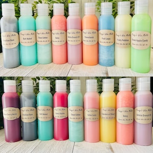 May include: A collection of 18 small glass bottles with colorful wax melts. The bottles are arranged in two rows of nine. The wax melts are in a variety of colors, including red, pink, blue, green, yellow, and orange. The bottles are labeled with names such as "Brazilian Bum", "Clean Cotton", "Daisy", "Delicia Drench 59", "Flowerbomb", "Fruit Loops", "Fruity Pebbles", "Green Apple Candy", "Black Cherry Merlot", "Cherry Slushie", "Cotton Candy", "Cupcakes at Tiffany's", "Daisy", and "Delicia Drench 59".