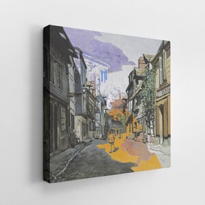 May include: A canvas print of a European street scene. The artwork depicts a narrow street lined with buildings, with a person walking down the street. The color palette includes shades of gray, brown, yellow, and purple, creating a vintage aesthetic.