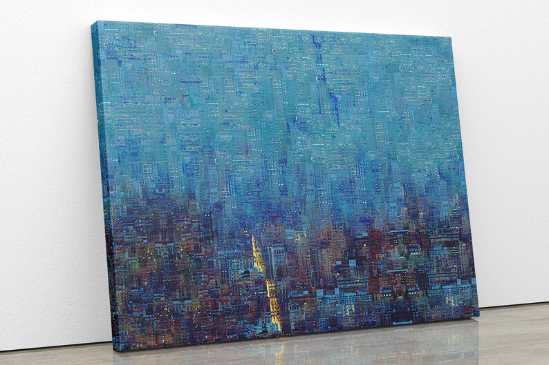 May include: Abstract cityscape art print on canvas. The artwork features a textured, layered design in shades of blue, with hints of orange and yellow. The canvas is mounted on a wooden frame, creating a modern aesthetic. The artwork is leaning against a white wall.