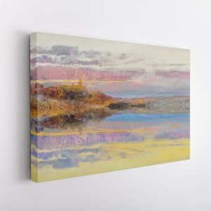 May include: A landscape canvas print featuring a serene waterscape with a reflective surface. The artwork showcases a sunset with pink and yellow hues, a distant shoreline, and a cloudy sky. The painting is mounted on a white wall.