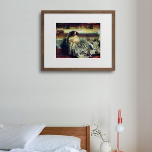 May include: A framed artwork depicting a woman in a flowing gown, resting on a sofa. The painting features a palette of muted greens, reds, and golds, with a focus on the textures of the fabric and the figure's pose. The frame is a warm brown.