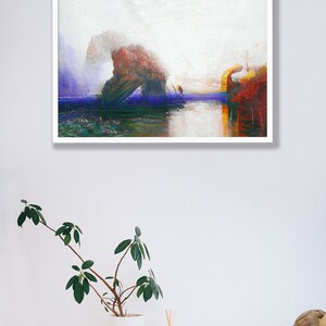 May include: Abstract landscape art print in a white frame. The artwork depicts a seascape with a rock formation in red, orange, and blue hues. The painting has a textured, painterly style, with a focus on colour and light.