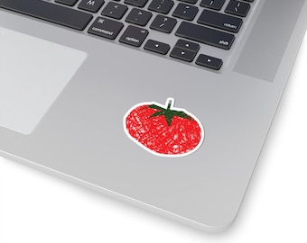 May include: A red tomato sticker with a green stem and white border. The tomato design has a scribbled texture. The sticker is placed on a silver laptop.