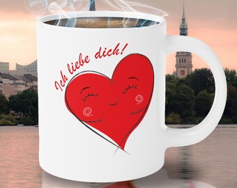Può includere: Tazza da caffè in ceramica bianca con un design a forma di cuore rosso e il testo "Ich liebe dich!" in nero. Il cuore ha un viso sorridente con gli occhi chiusi.
