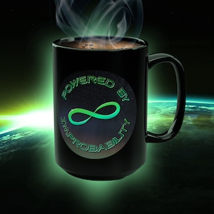 May include: Black coffee mug with a green and blue infinity symbol and the text "Powered by Improbability" on a white circle sticker.