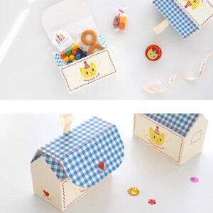 May include: A set of three white and blue gingham gift boxes with a cat design. The boxes are decorated with a red heart and the text "Congratulations" and "I love you".